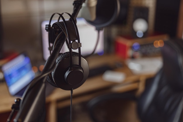 Photo professional microphone and headphones in the workplace for broadcasting and music rehearsal space