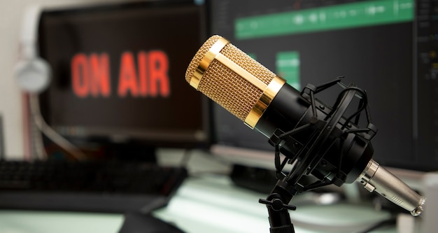 Professional microphone on work table for podcast broadcasting or radio speech