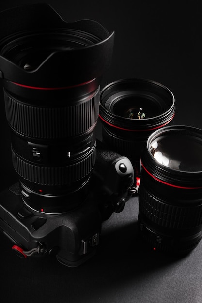 Professional mirrorless camera with premium lenses in dark background