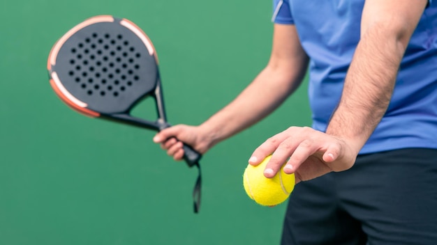 Professional monitor of padel holding a yellow ball and black racket Sport game