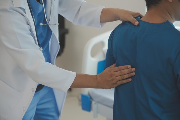 Professional orthopedist examining little patient's leg in clinic