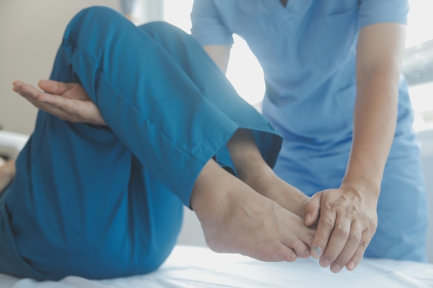 Professional orthopedist examining little patient's leg in clinic