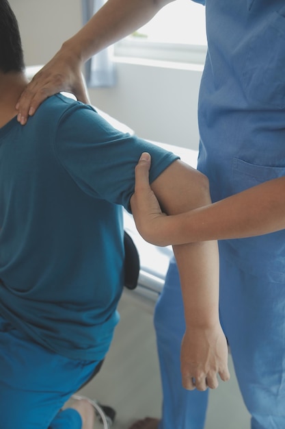 Professional orthopedist examining little patient's leg in clinic