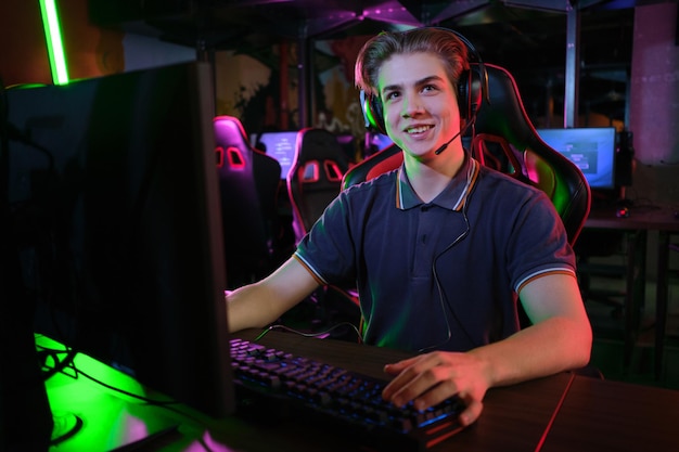 Professional photo of young male caucasian cyber sportsman in gaming club training for important match.