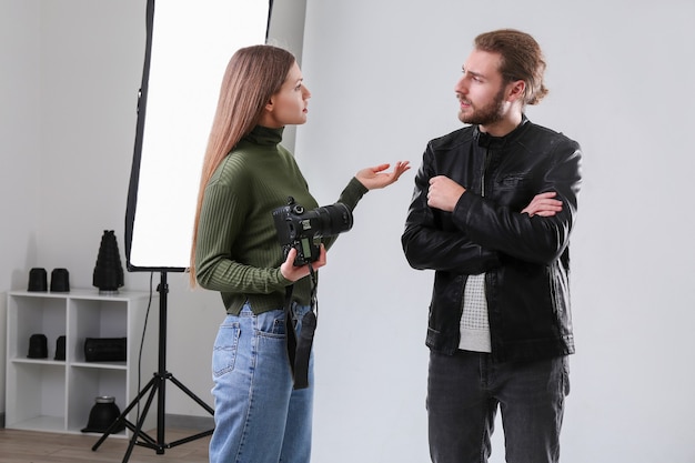 professional photographer with model in studio