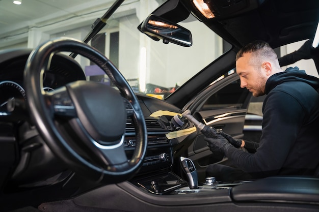 Professional polishing car interior trim.