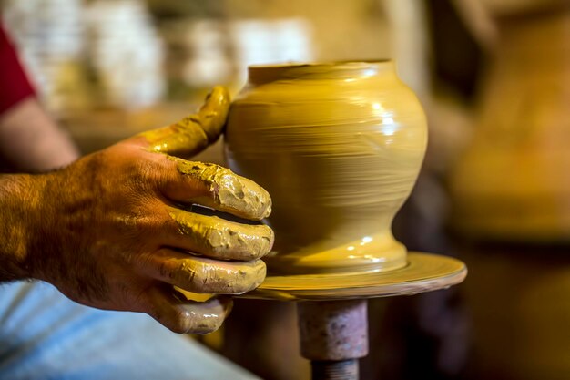 Professional potter making bowl in pottery workshop, studio.