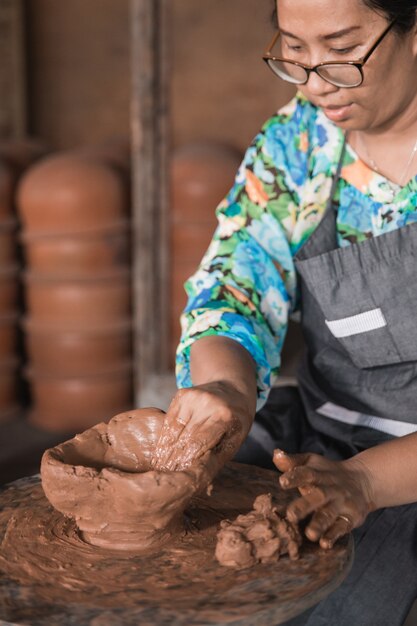 Professional pottery maker working with clay