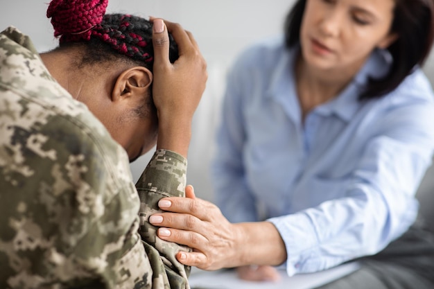 Professional psychiatrist helping black military woman overcome posttraumatic stress disorder