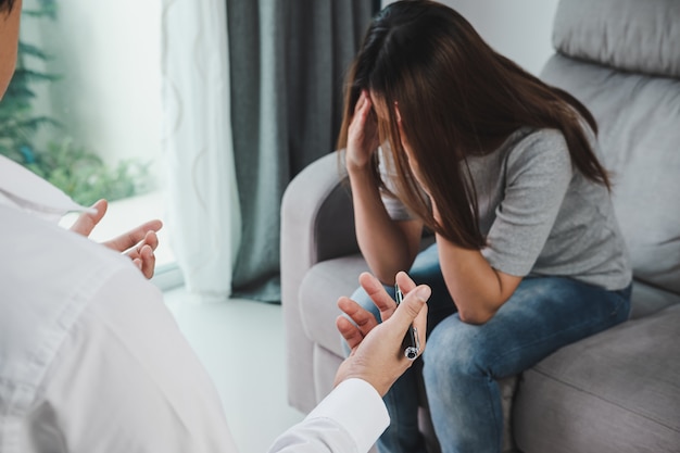 Professional psychologist doctor consulting his depressed patient