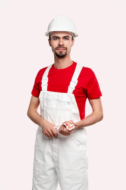 Professional repairman in workwear looking at camera