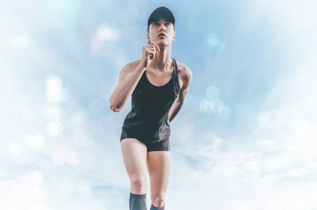 Professional runner stands on the track and prepares for the start of the race. Sports concept.