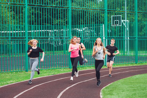 Professional runners running on a race track.