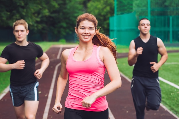 Professional runners running on a race track.