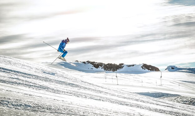 Professional skier performing acrobatic jump on downhill exhibition