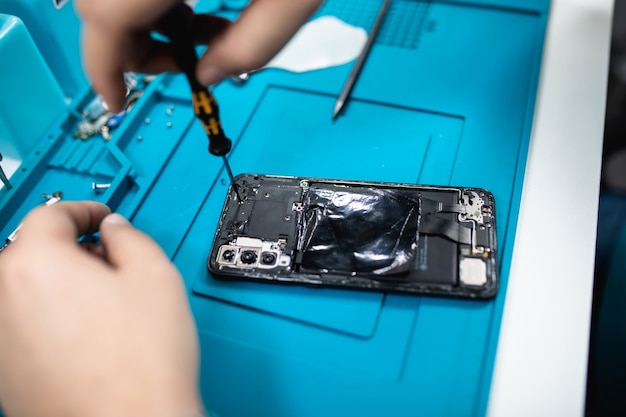 Professional smart phone repair shop or service. Close up shot. Electronics concept.