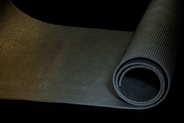 Professional sport equipment isolated on black studio background. Exercise mat.