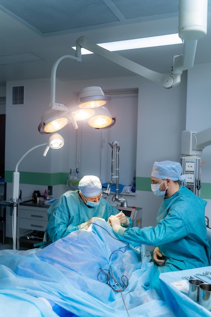 現代の病棟で働く専門の外科医手術をしている医療服のカップル