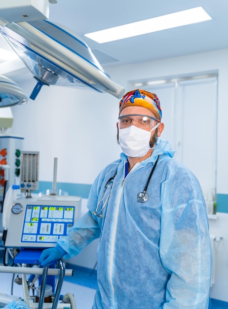 Professional surgery specialist in medical uniform and mask Male doctor in blue uniform and protective medical mask