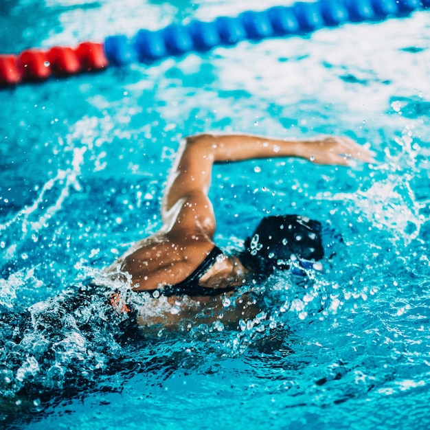 Professional swimmer swimming race indoor pool