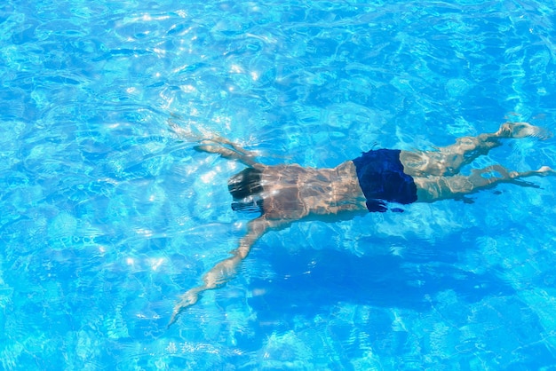 Professional swimmer underwater after the jump