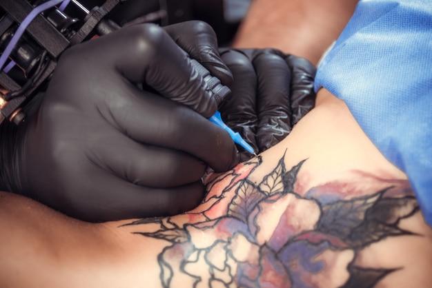 Professional tattoo artist formulates a tattoo the salon.