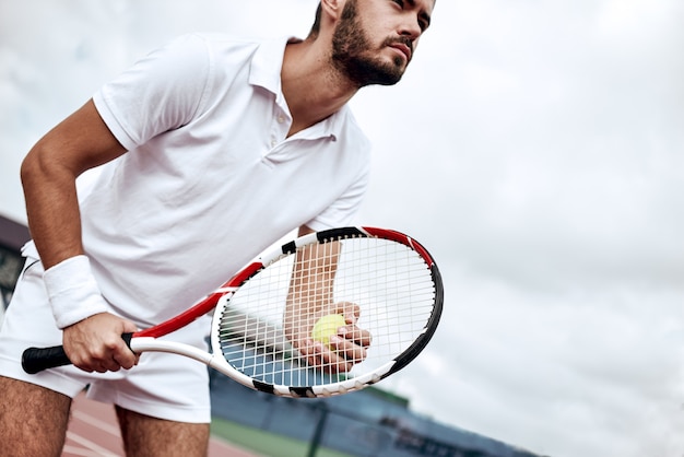 Professional tennis player man athlete waiting to receive ball playing game on hard court fitness