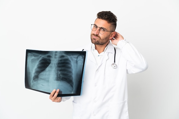 Professional traumatologist isolated on white wall having doubts