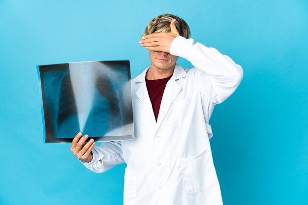 Professional traumatologist man covering eyes by hands. Do not want to see something