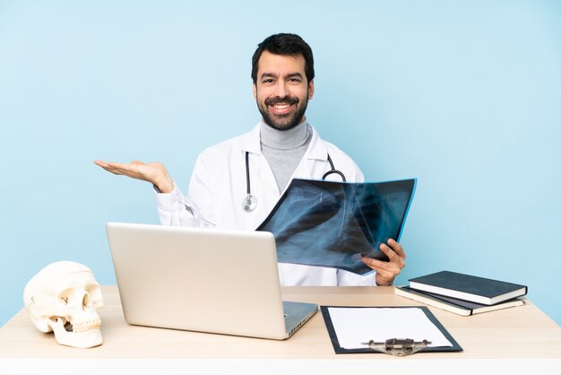 Professional traumatologist in workplace holding copyspace imaginary on the palm to insert an ad