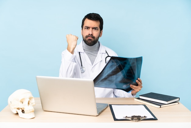 Professional traumatologist in workplace with angry gesture