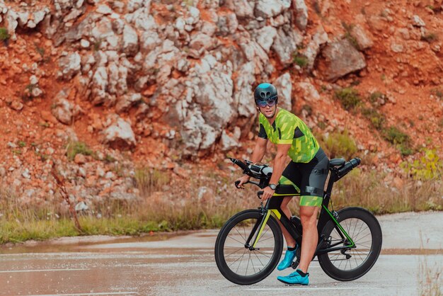 A professional triathlete preparing for a training ride on a bicycle.