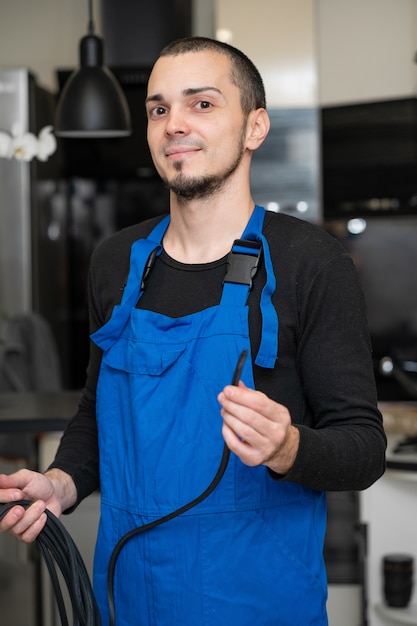 Professional window repair and installation technician holding a rubber gasket for pvc windows in his hand.