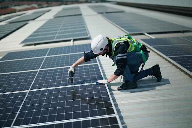 Professional worker installing solar panels on the roof of a house