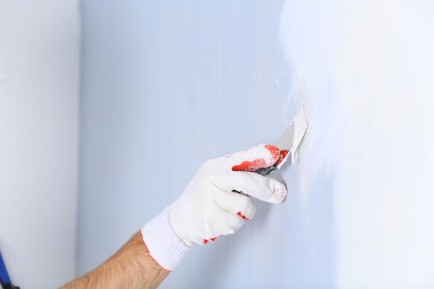 Professional worker making repair in room