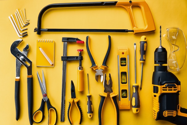 Photo professional workshop instrument, top view. carpenter tools, builder equipment, screwdriver and piles, hacksaw and level, scissors and drill