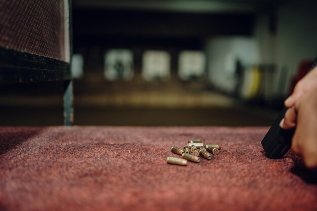 Professionals practice shooting a 9mm pistol inside a shooting range