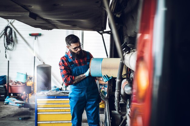 Professionele busmonteur die werkt in de autoreparatieservice.