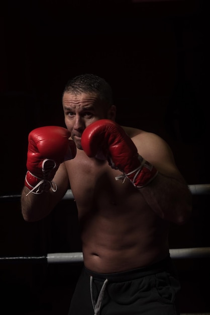 professionele kickbokser met handen in vechtsportpositietraining voor het gevecht in de trainingsring