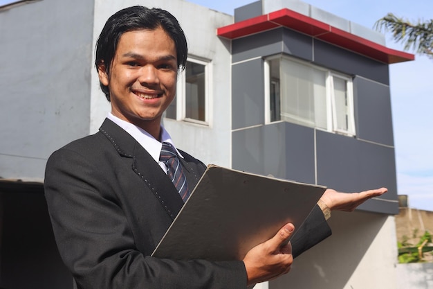 Professionele makelaar met een clipboard die een nieuw huis toont en presenteert Bedrijfsmarketing