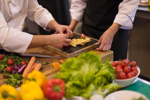 Professionele teamkoks en chef-koks bereiden maaltijden in de drukke hotel- of restaurantkeuken