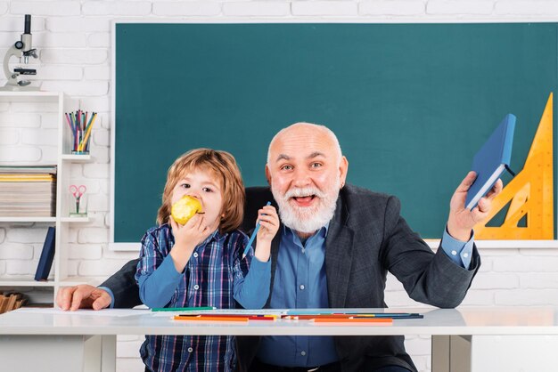 Professor and pupil in classroom at the elementary school senior teacher in classroom with elementar