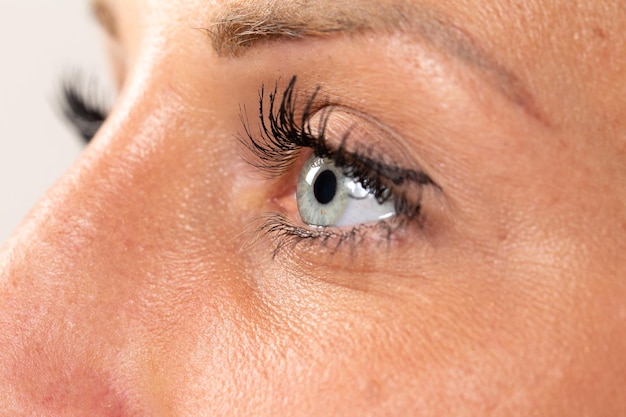 Profile closeup of a young woman39s blue eye with light make up