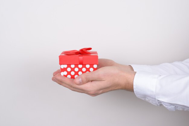 Profile photo of hands holding giftbox isolated grey background