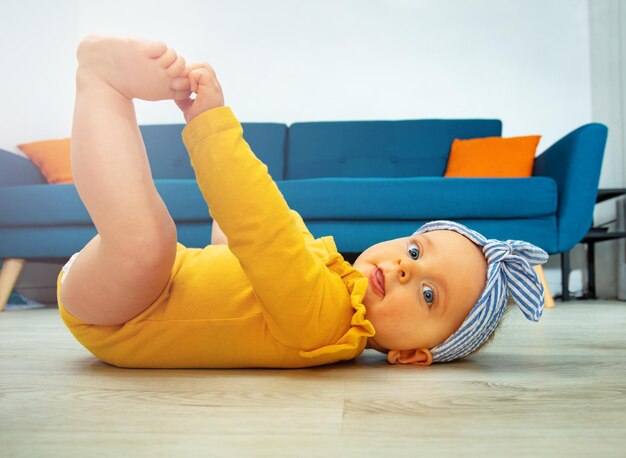 Profile photo of a little baby girl touching legs