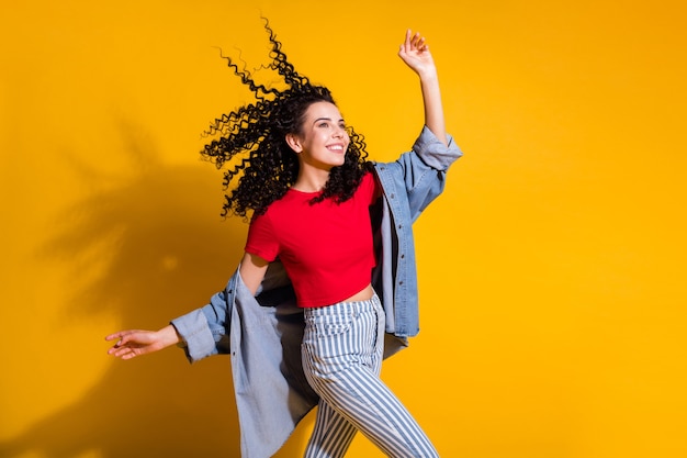 Photo profile photo of pretty lady look empty space air blow hair wear striped jeans cropped red t-shirt jacket isolated yellow color background