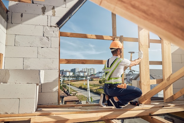 Profile photo of serious builder that being on the top floor of large construction