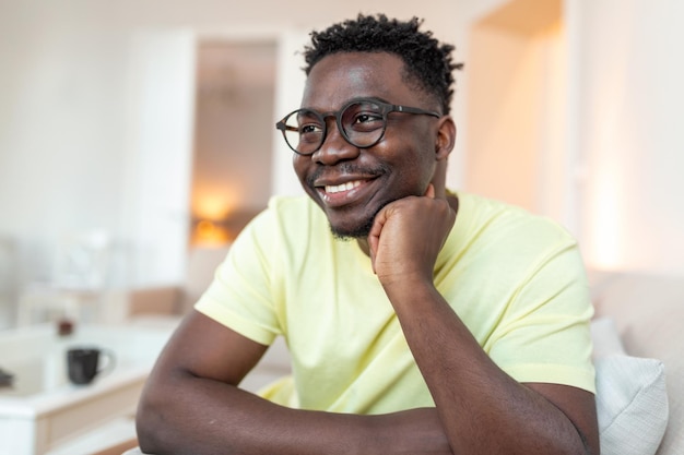 Profile picture of smiling young African American man in glasses pose in own home apartment Close up headshot portrait of happy millennial biracial male renter or tenant in spectacles show optimism