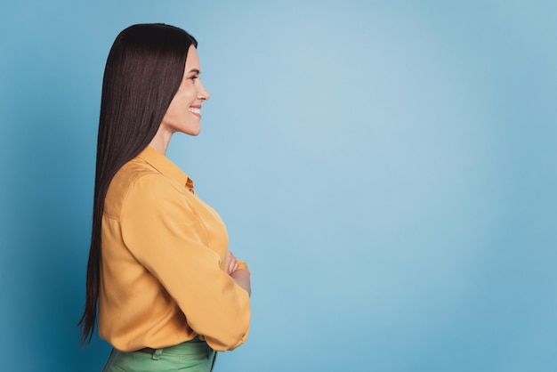 Profile portrait of business woman with crossed arms look empty space