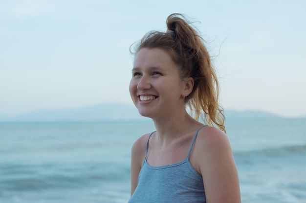 profile portrait of a european beautiful young girl on the sea ocean and relaxes happy woman